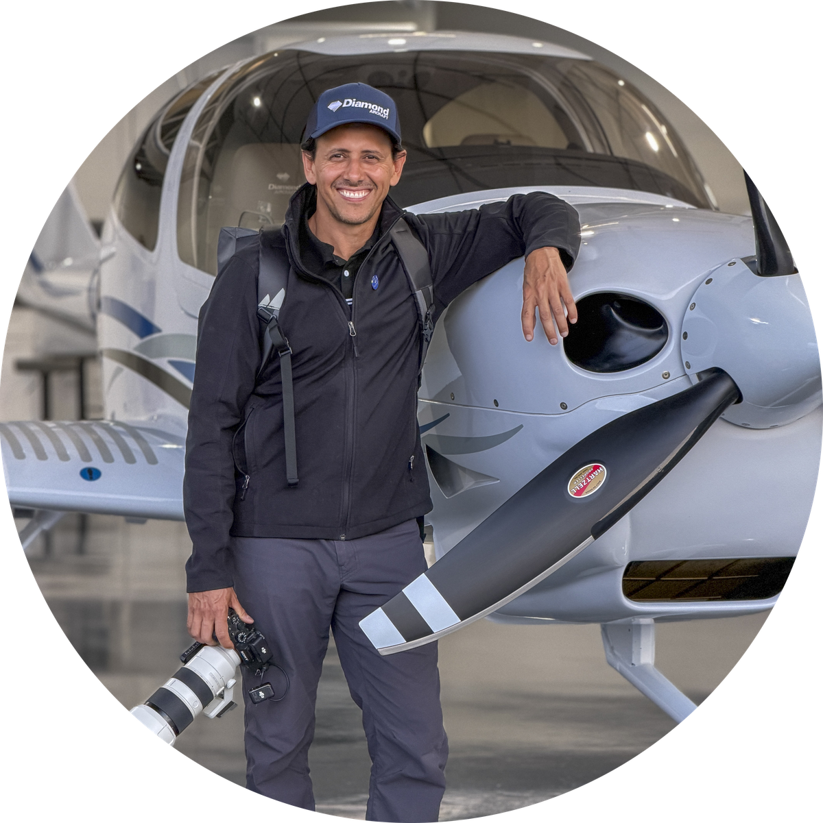 Gustavo Moser, commercial pilot and photographer, in front of a Diamond aircraft