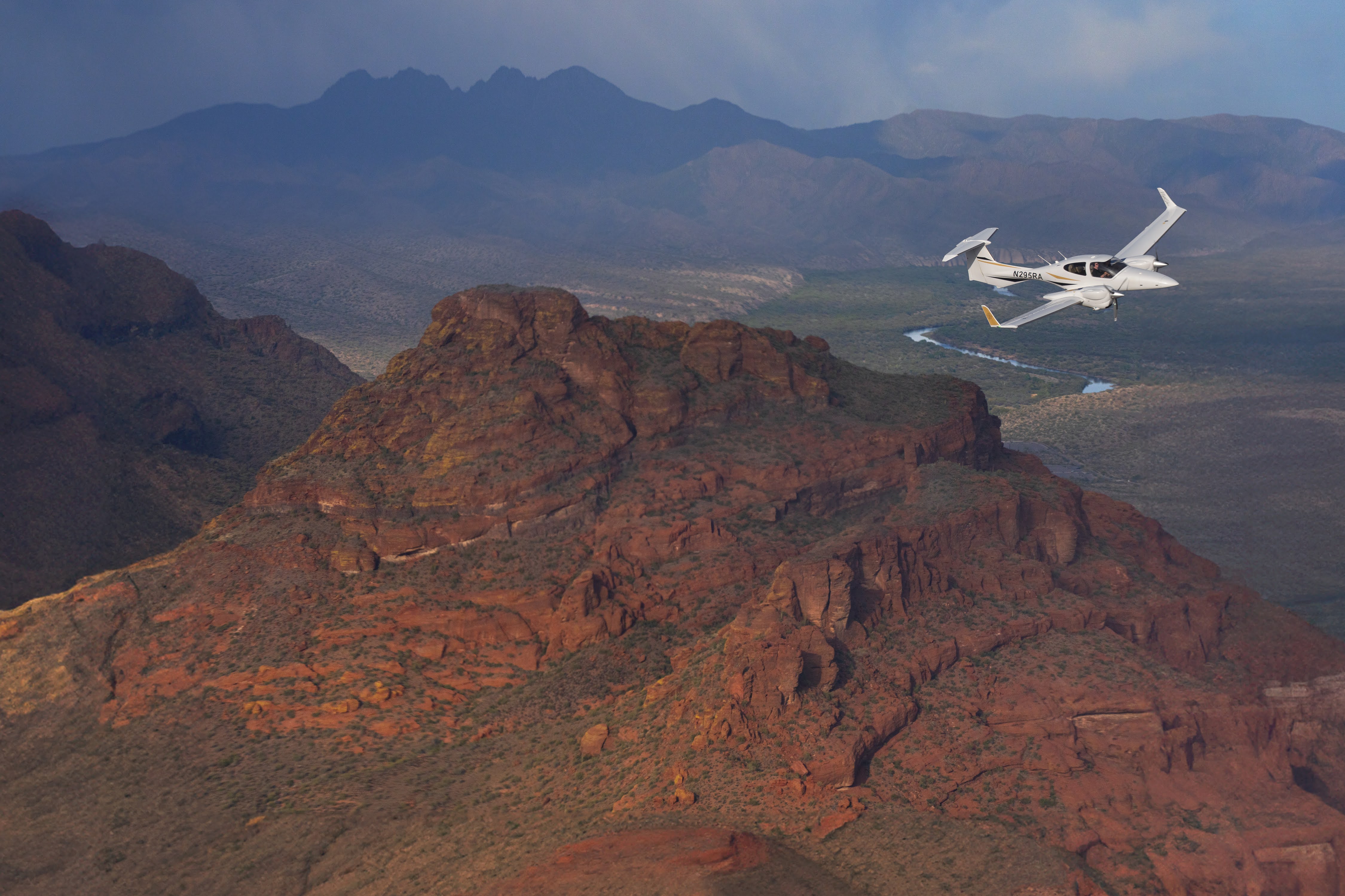 Diamond twin air-to-air over the red-rock mountains of Arizona